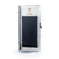 Clear container with brown false eyelashes on a white background, featuring the Lovely Lashes brand.